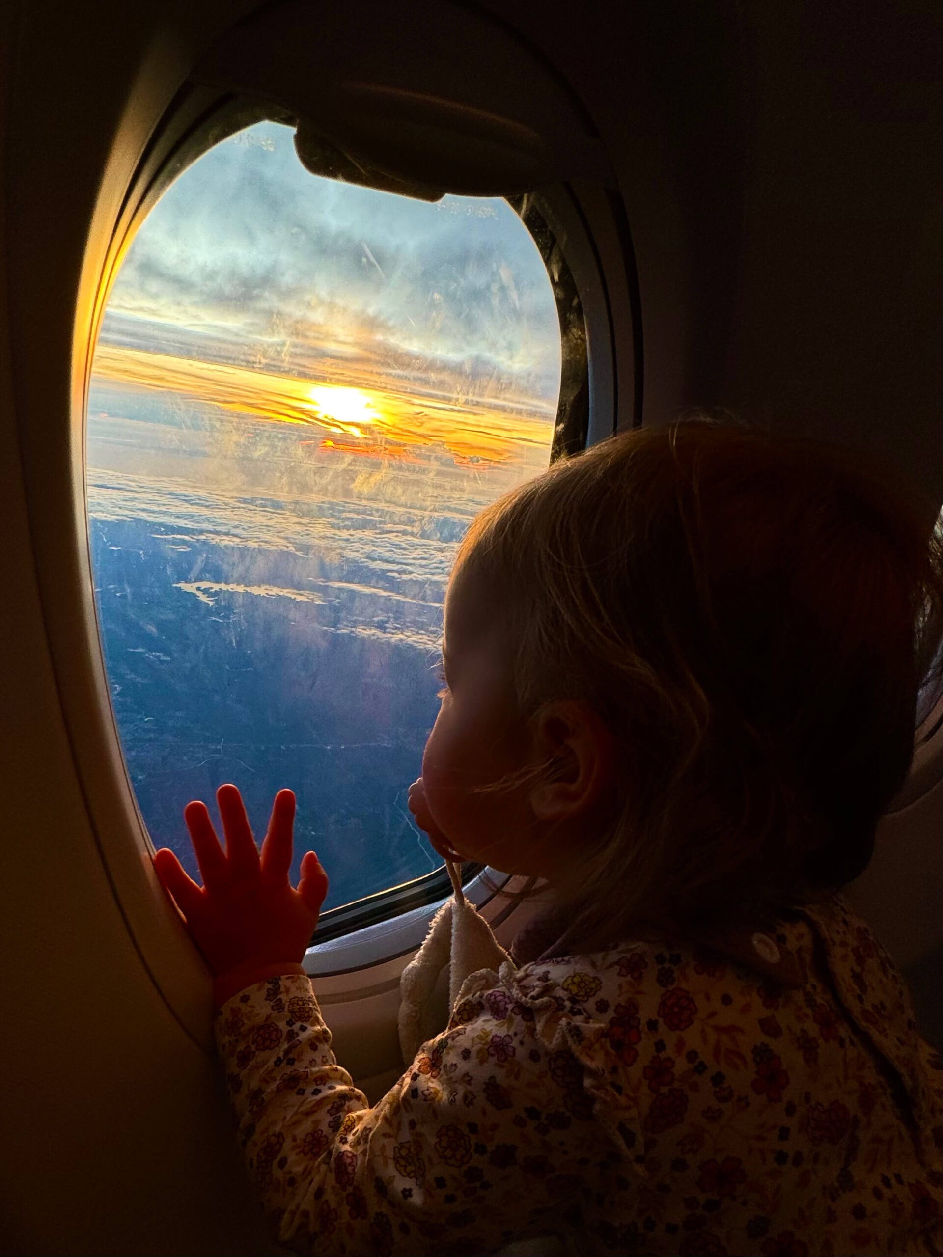Baby in airplane getting ready for sleep using a inflatable bed