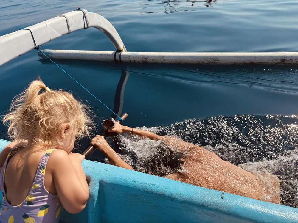 Dolphin tour in Lovina with kids, watching from the boat