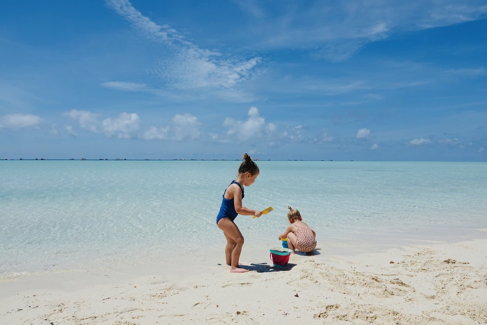 Children playing in the sand on Timba Timba Island near Semporna
