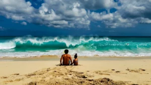 Father and daughter watching waves at Dreamland beach in Bali