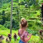 Young child exploring the Tegalalang rice terraces near Ubud, one of the best areas in Bali for nature and culture