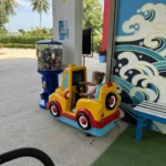 Toddler riding a coin-operated car at Splash Jungle Water Park Phuket