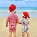 Children celebrating Christmas on Kamala Beach in Phuket, Thailand during a family trip