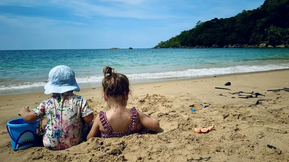 Baby and toddler enjoying the beach in Khao Lak, Thailand