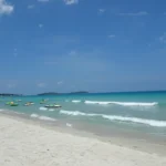 Family walking along Chaweng Beach on Koh Samui, Thailand