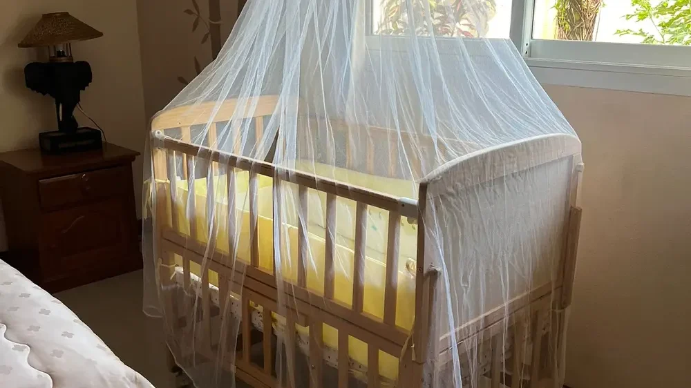Baby cot provided in a family-friendly hotel room