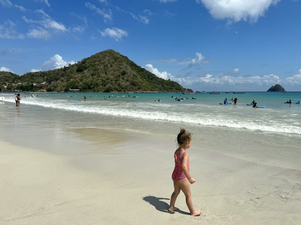 Young child playing on the wide sandy beach of Selong Belanak in South Lombok