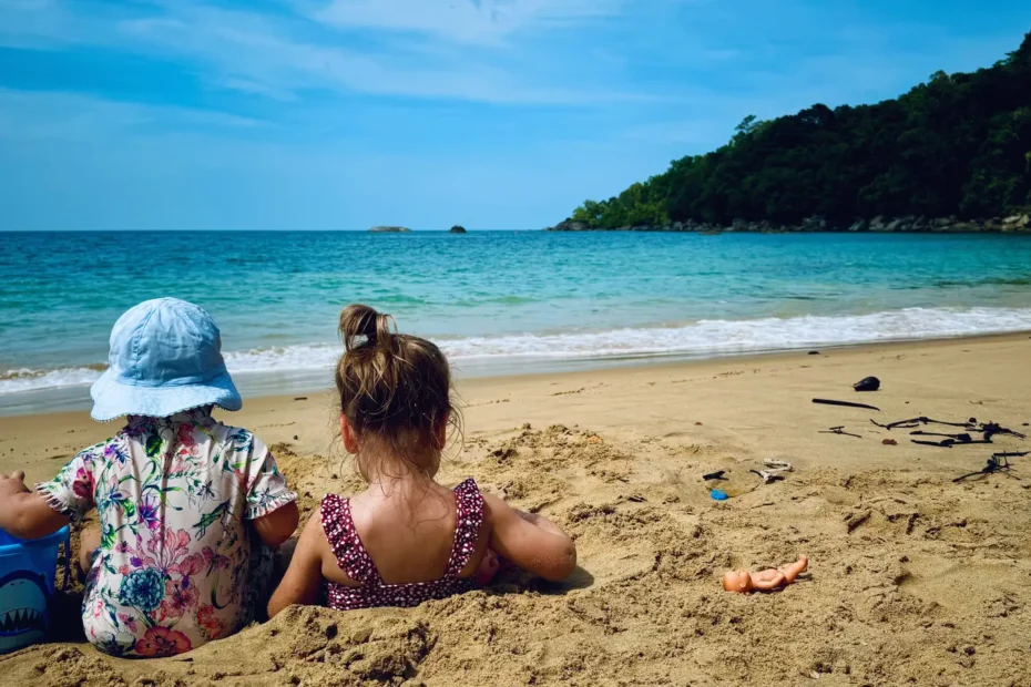 Two young children playing on the beach in Khao Lak, Thailand