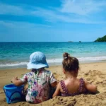 Toddlers playing on the beach in Khao Lak with kids