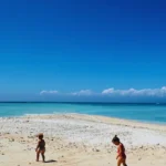 Children playing on the white sand beach of Gili Kapal in East Lombok