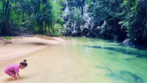 Child exploring a tropical lagoon during an island tour in Thailand