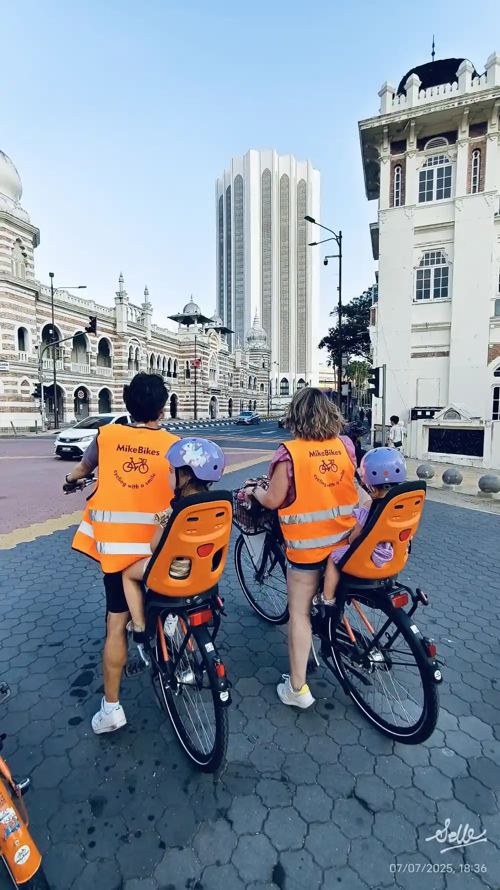 family bike tour through Kuala Lumpur city center during a Malaysia trip with kids