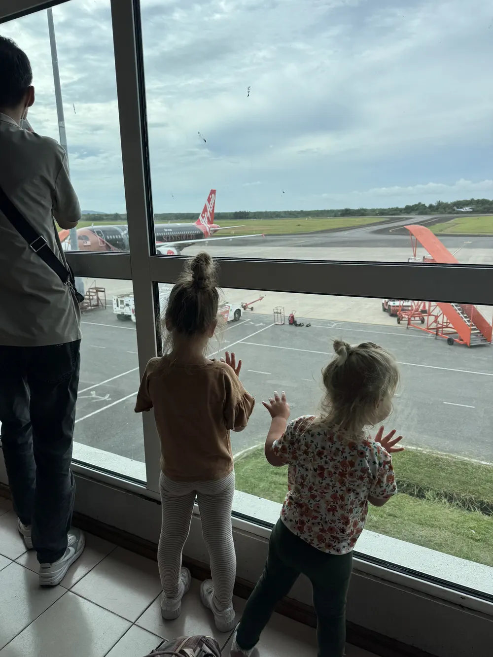 Baby and toddler waiting to board the airplane