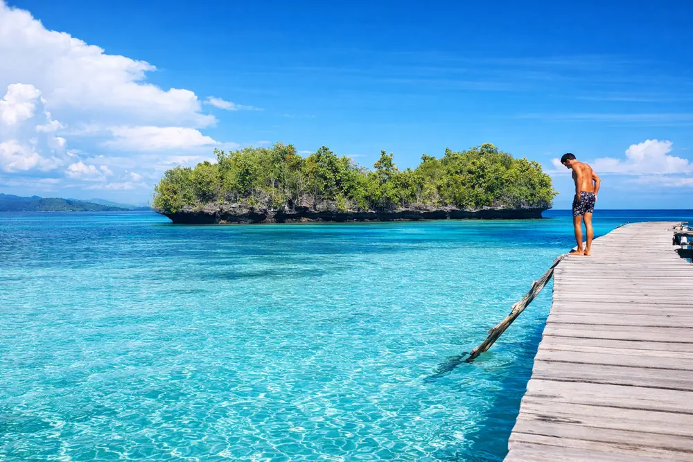 Pier leading to overwater bungalow in Raja Ampat Indonesia