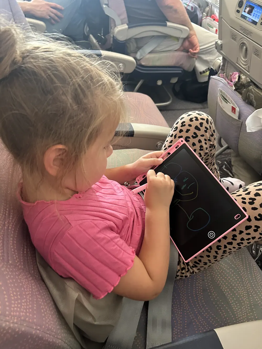 Kid drawing during a long flight