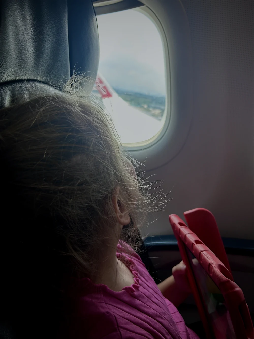 Toddler using tablet during flight