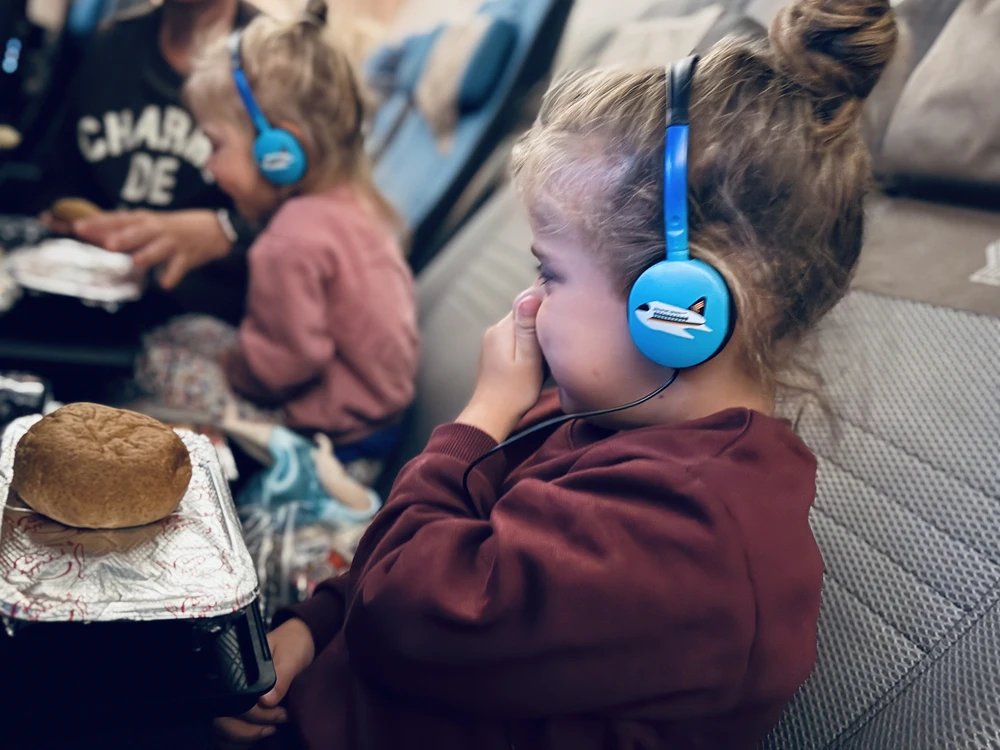 Toddler refusing airplane food during a family flight