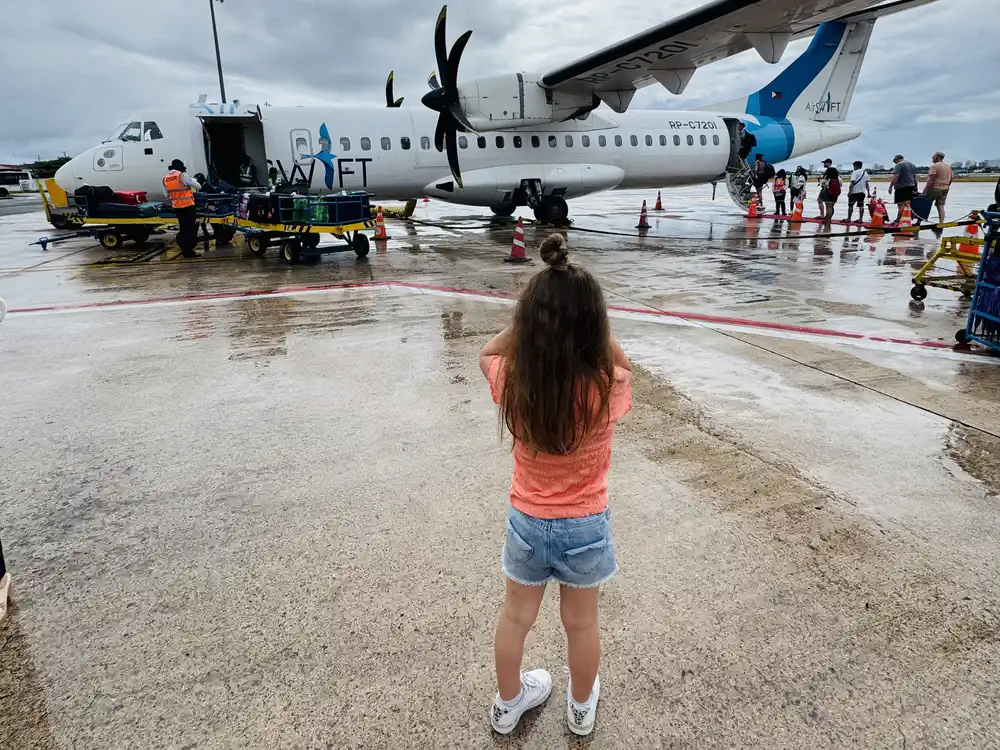 Toddler watching airplanes before boarding