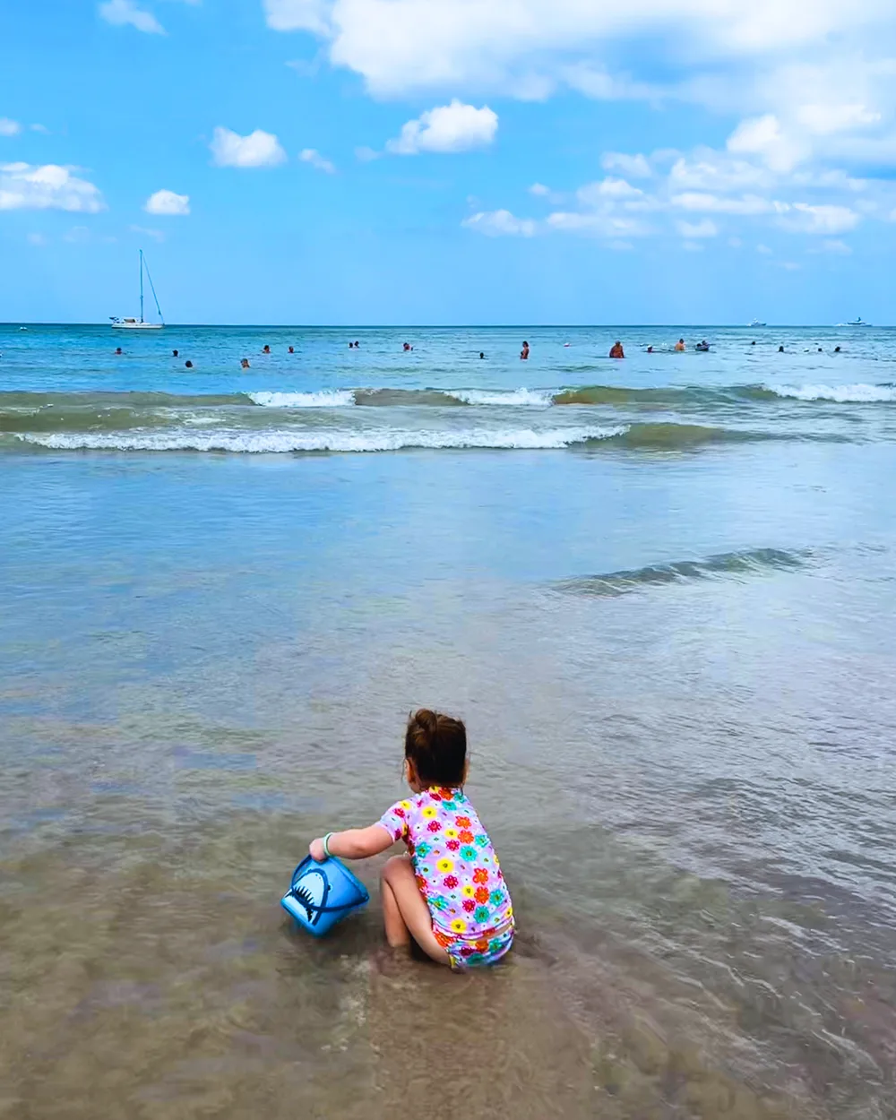 Young child playing in the ocean during a Phuket family holiday