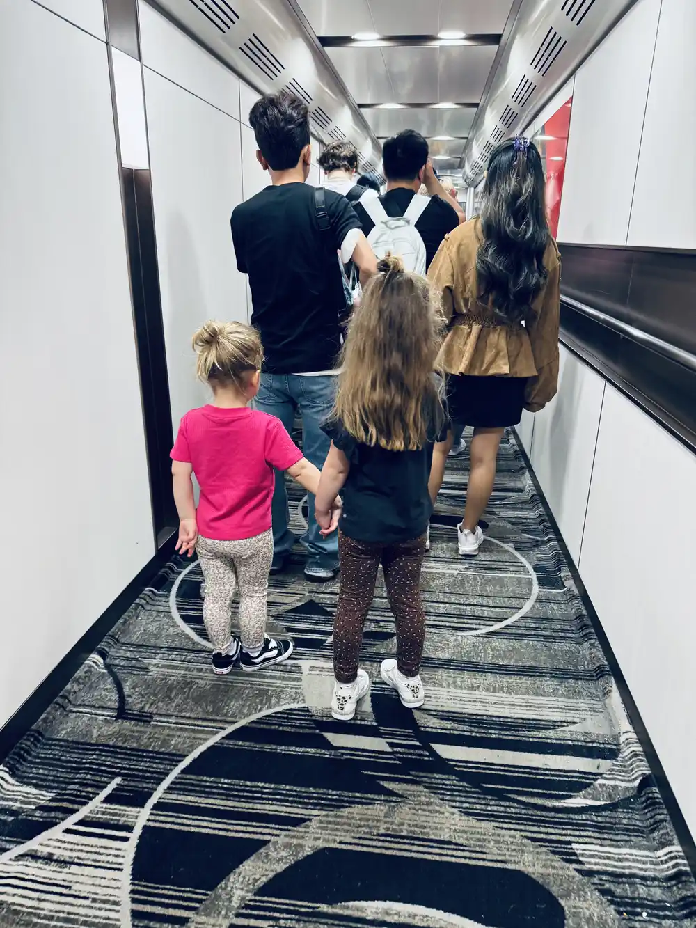 Sisters waiting at the boarding gate before a family flight