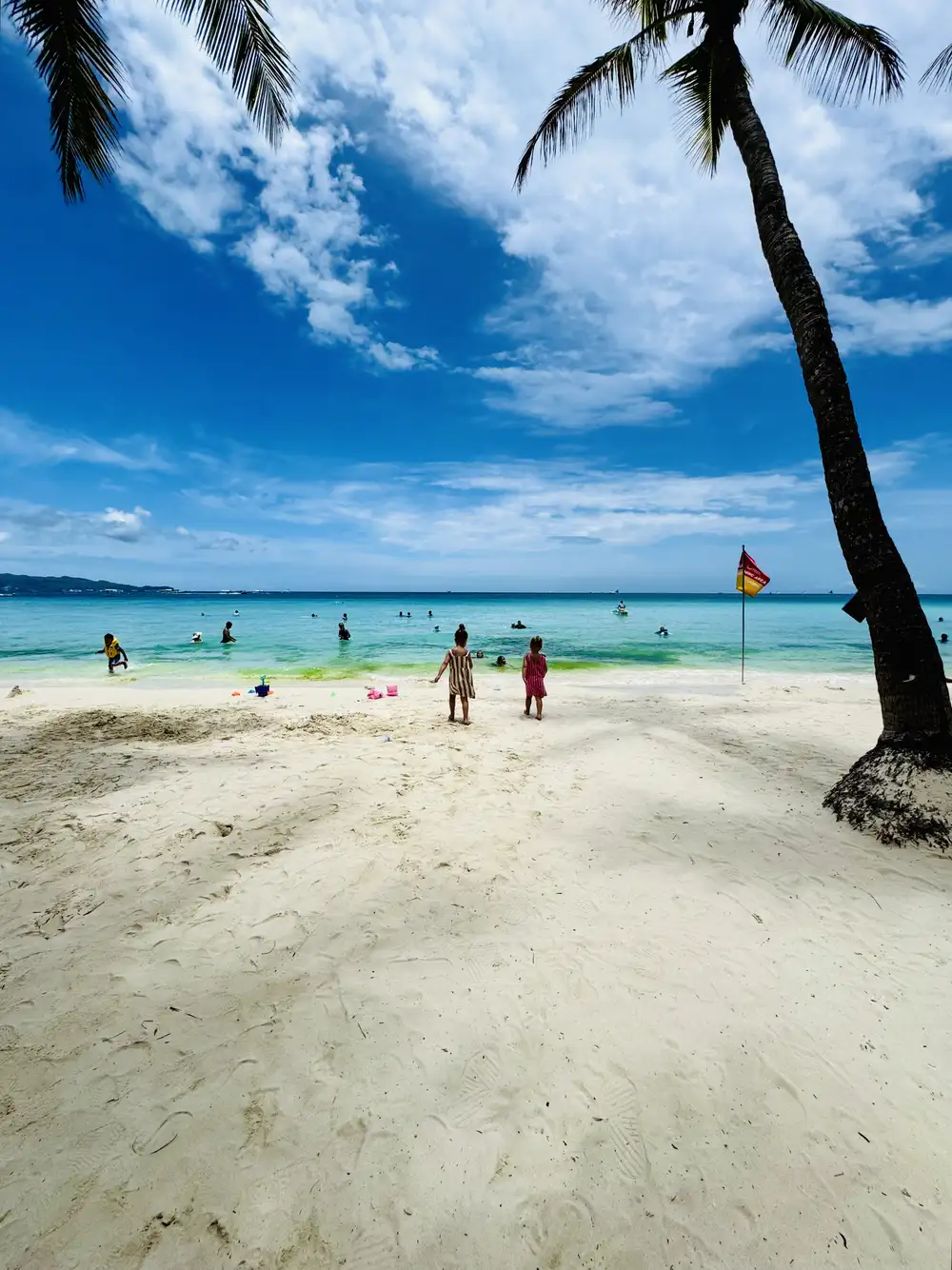 Children walking towards White Beach in Boracay, Philippines
