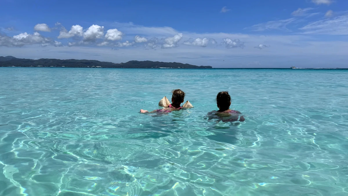 Children playing in the shallow waters of Boracay, Philippines