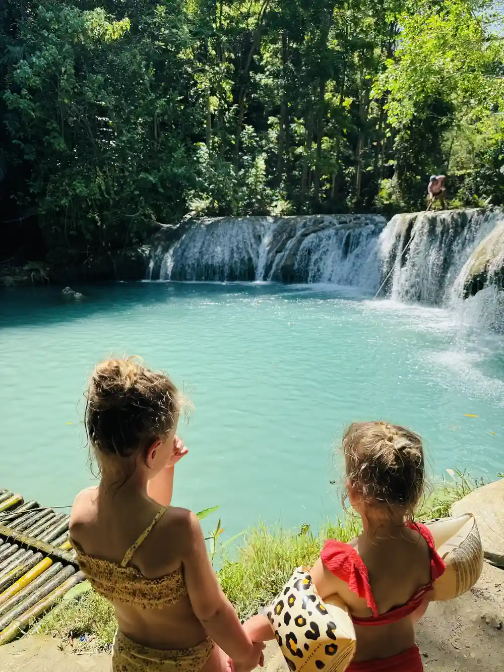 Children watching Cambugahay Falls in Siquijor, Philippines