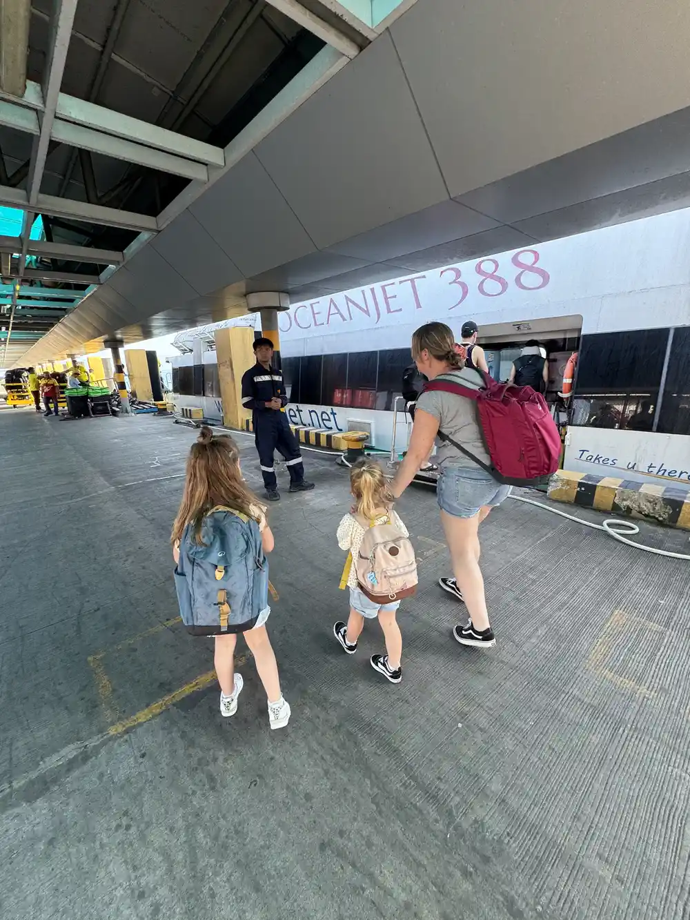 Family boarding a ferry between Bohol and Siquijor while traveling the Philippines with kids