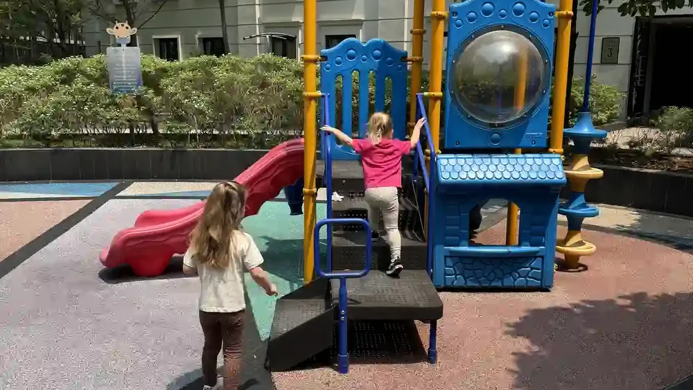 Children playing on a playground during a family trip to the Philippines