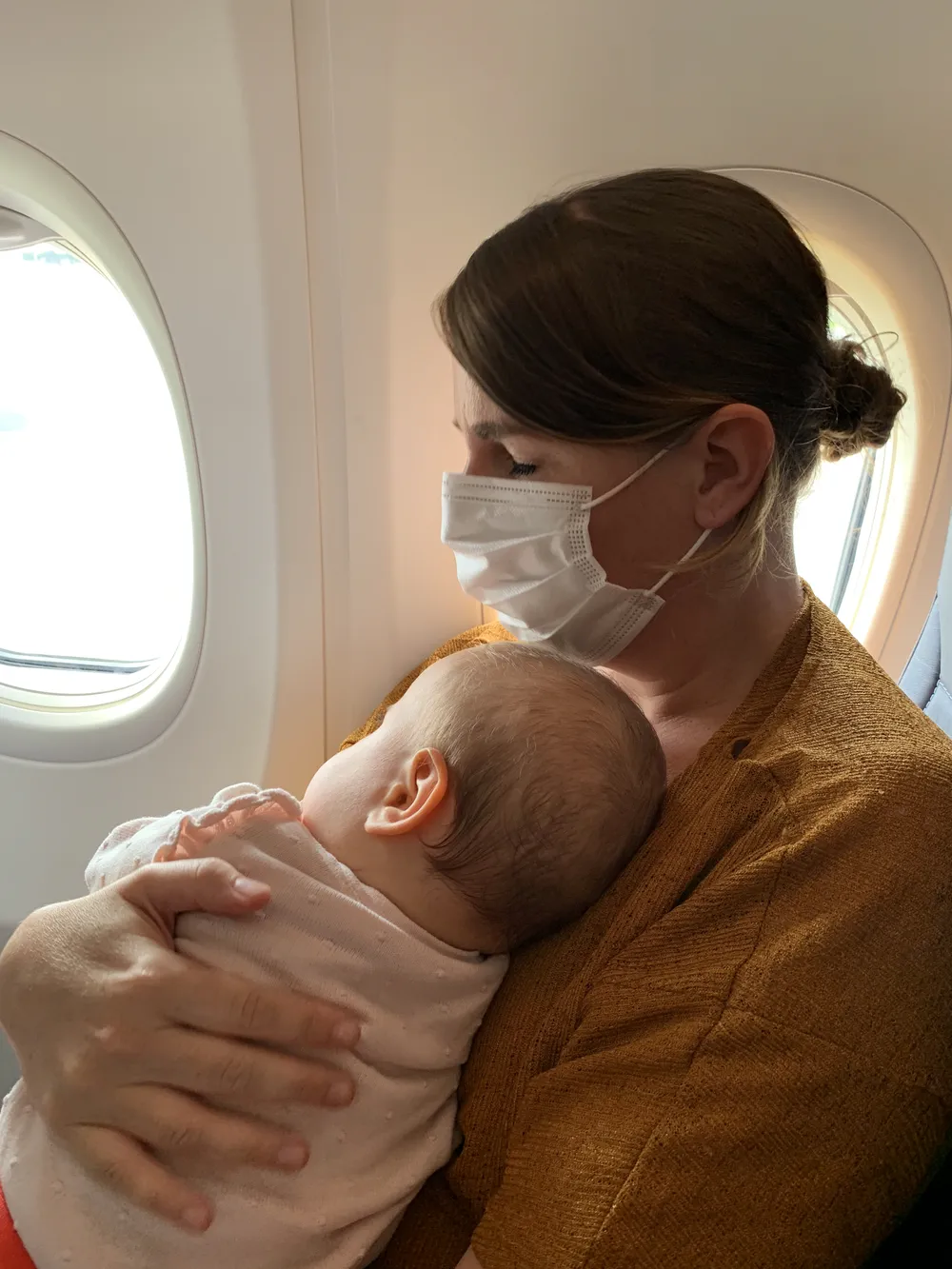 Mother and baby sleeping together during takeoff on a long-haul flight