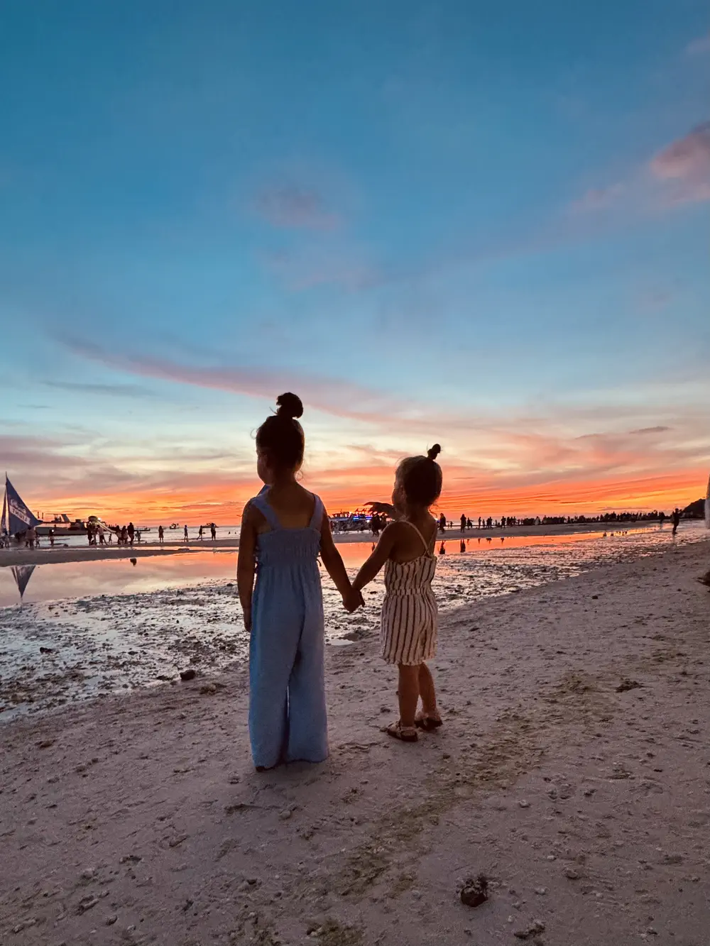 Sunset over White Beach in Boracay with our daughters playing on the beach