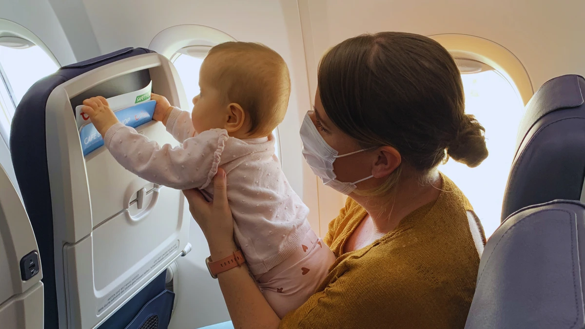 Baby looking out of an airplane window during our first family flight