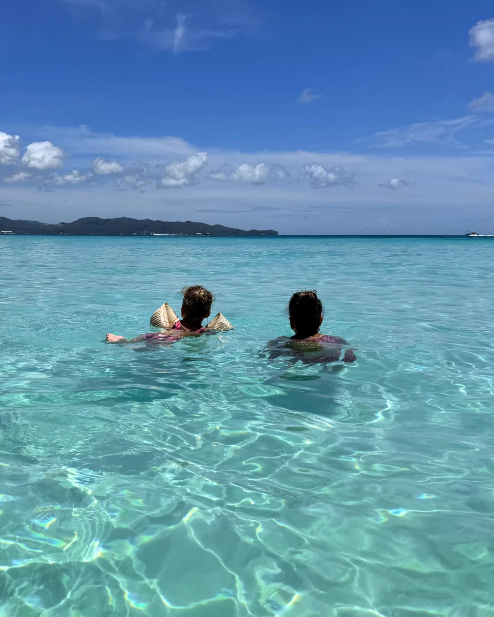 Our daughters swimming in the calm sea at White Beach, Boracay