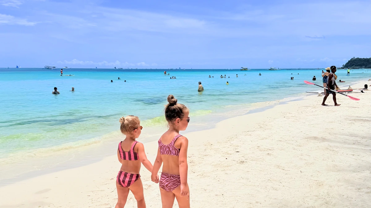 Our daughters walking along White Beach in Boracay