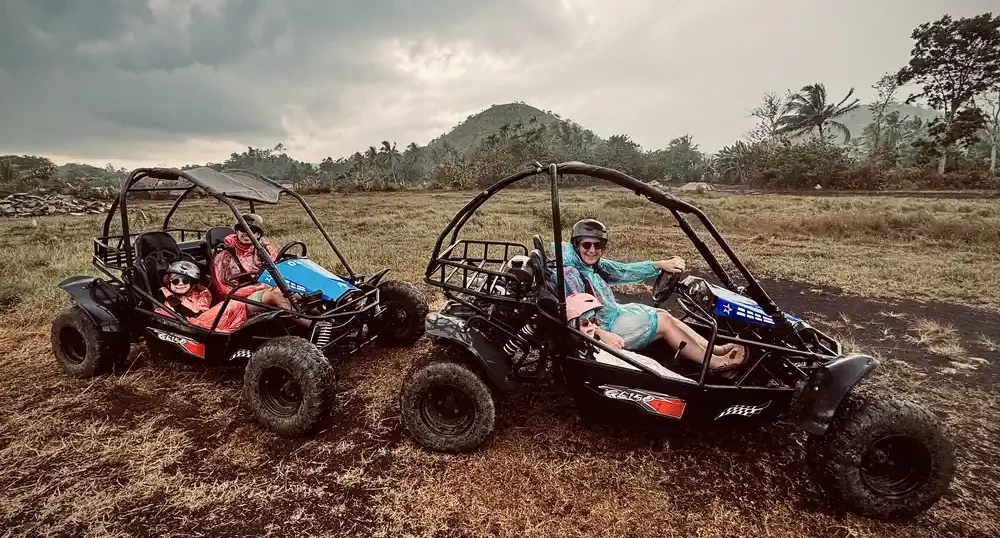 Our family riding ATVs in the rain during a countryside tour in Bohol