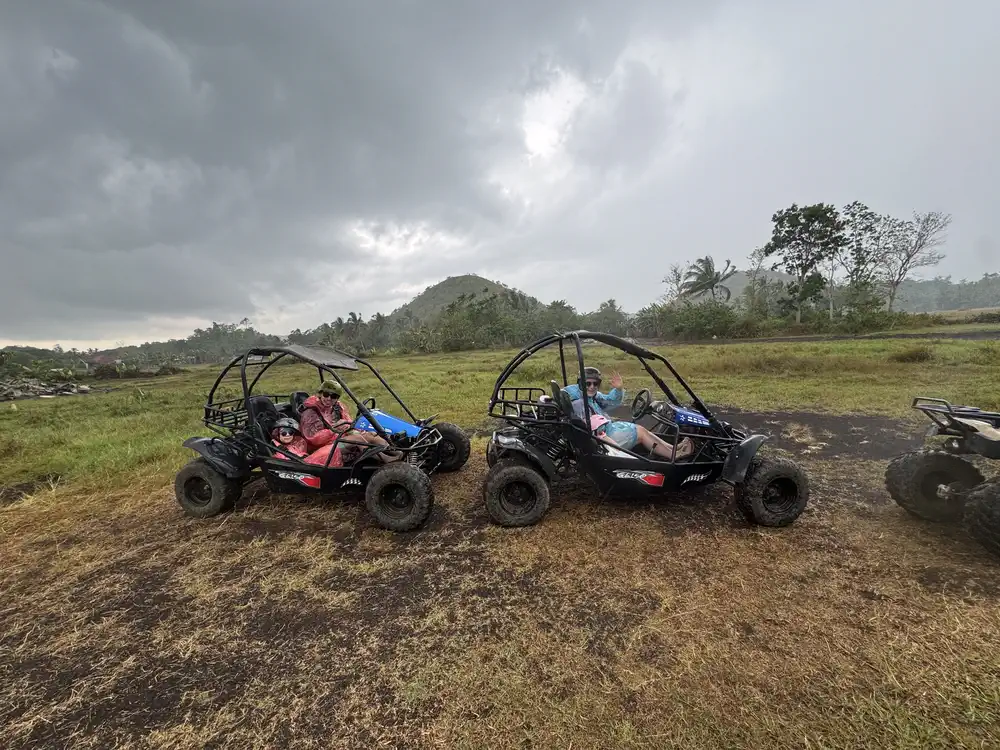 Our family riding ATVs in the rain near the Chocolate Hills in Bohol