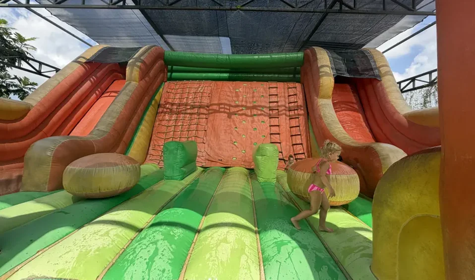 Our daughters going down a slide at Mookiland in Bali