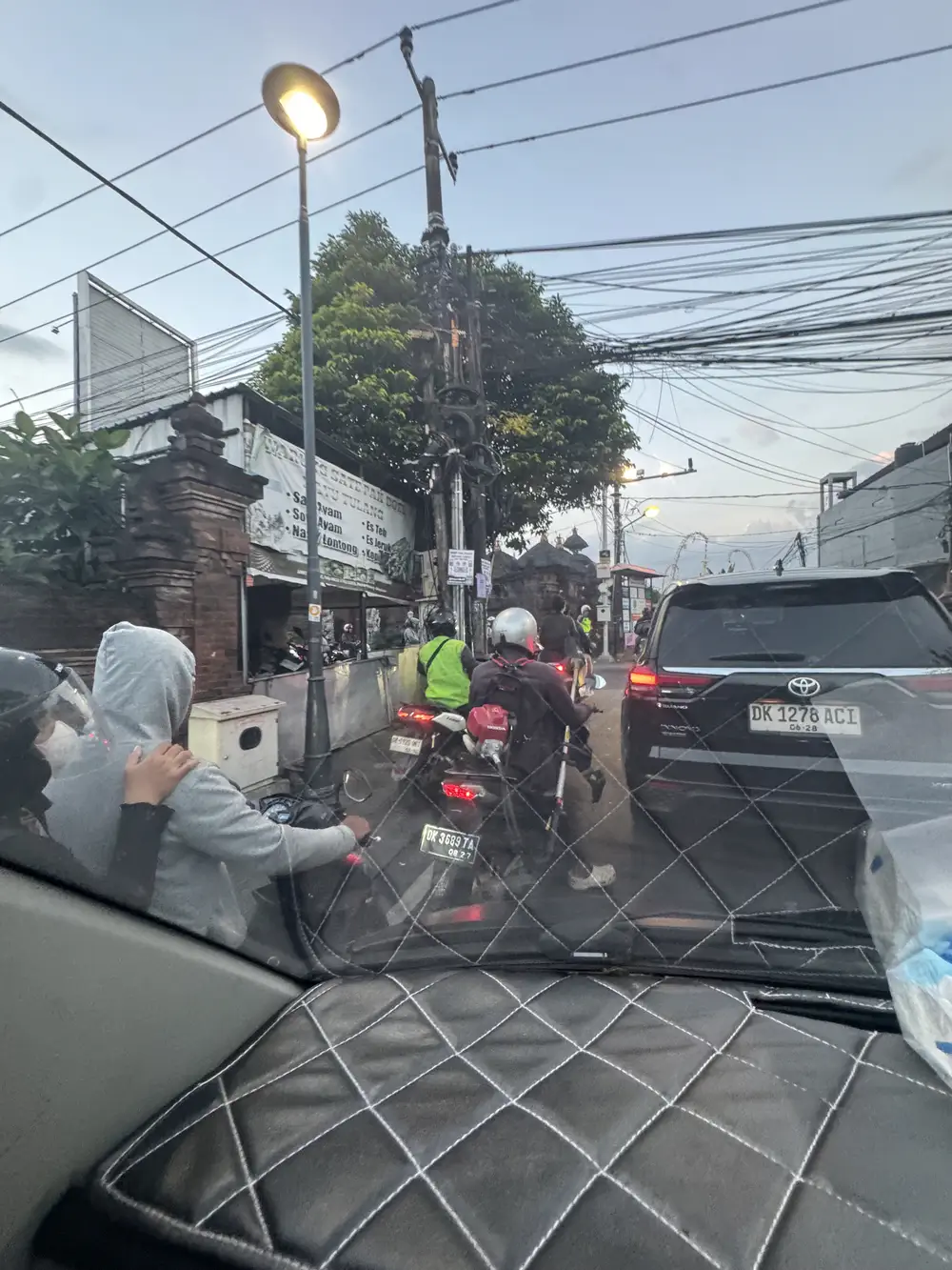 Busy traffic and scooters on a road in Canggu, Bali