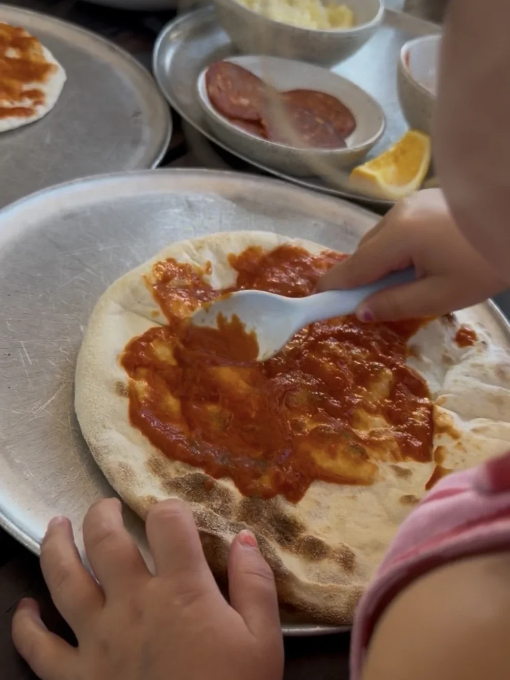 Our daughter making her own pizza at Milk & Madu Canggu