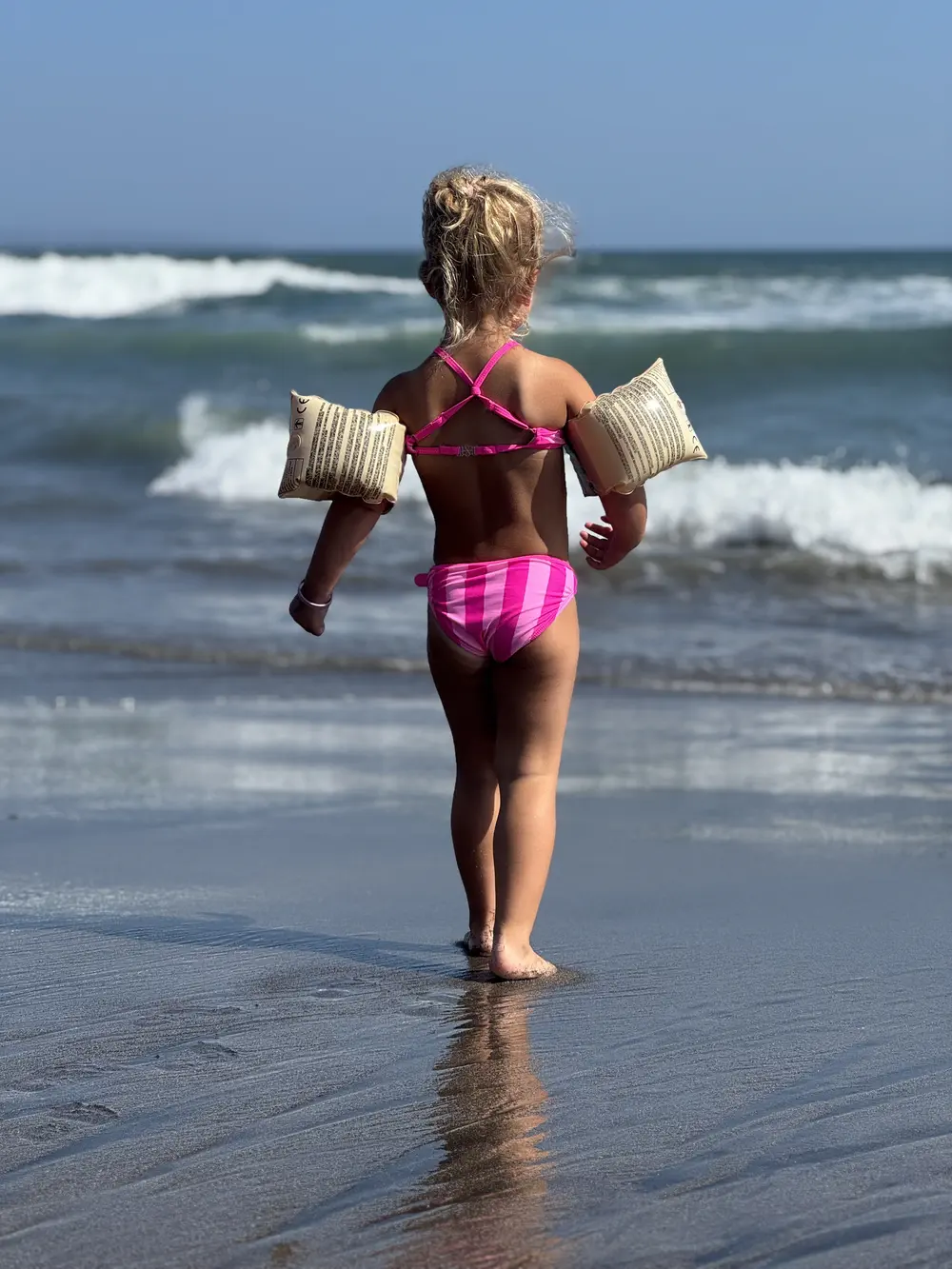 Kid playing in the waves on Canggu Beach near La Brisa